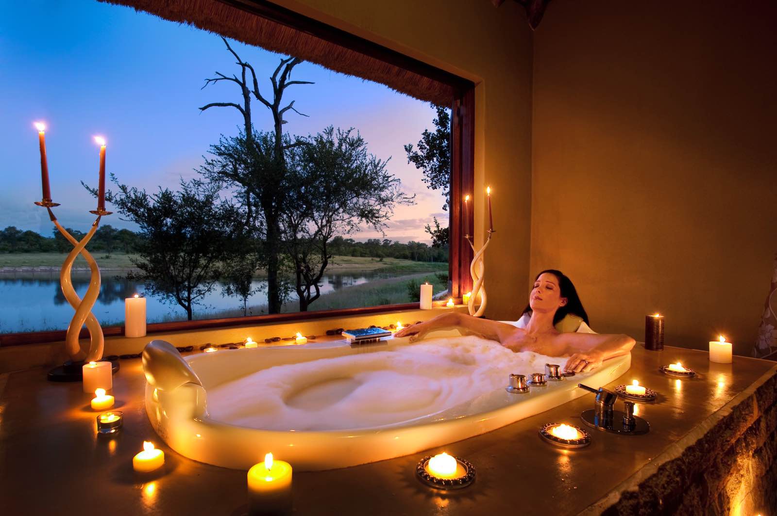 Candlelit bath with a view of the waterhole at Arathusa Safari Lodge spa
