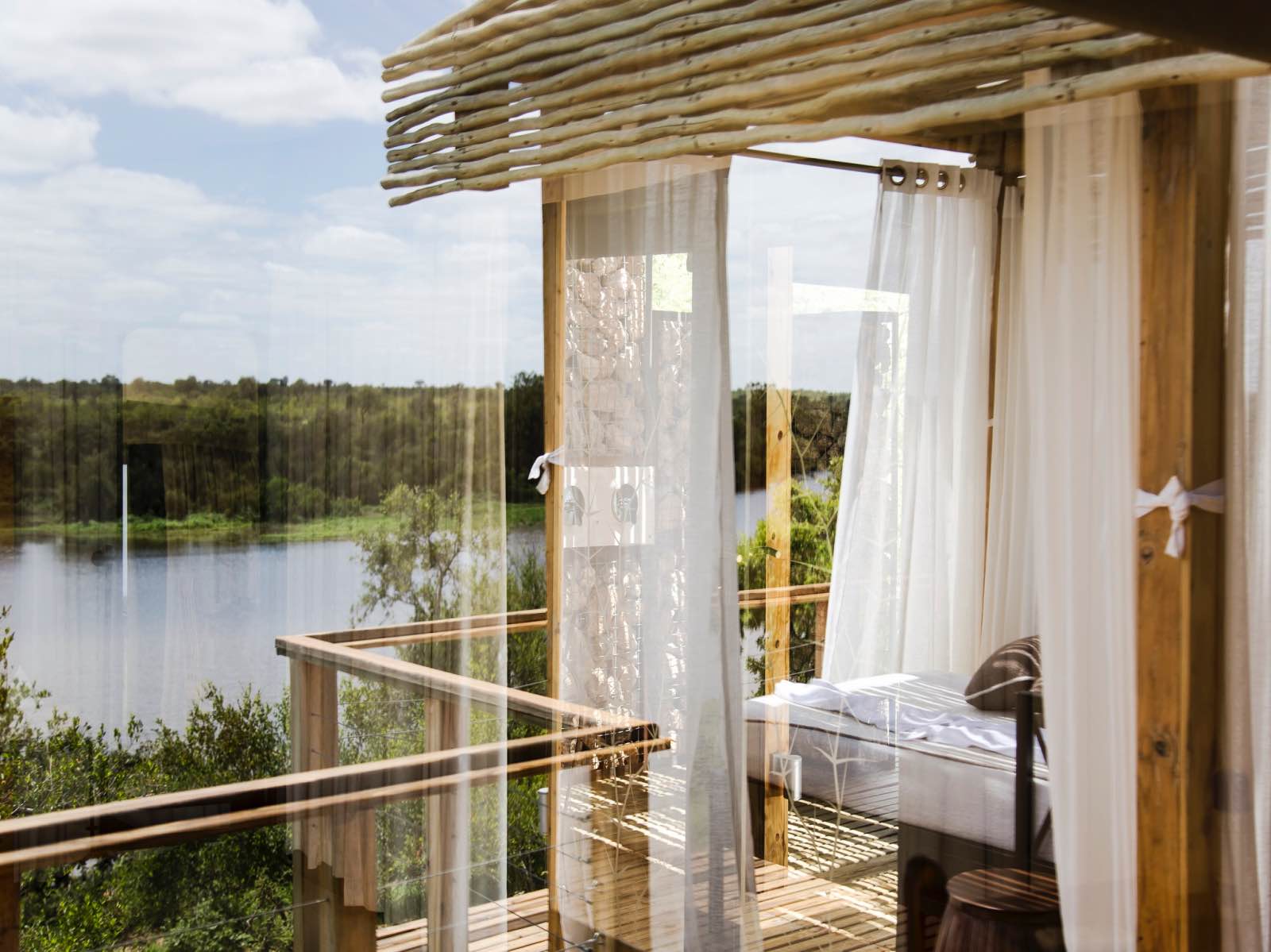 Simbavati Hilltop Lodge romantic outdoor bedroom with views of the river below