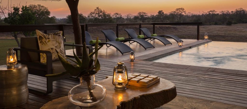 Sunset at the infinity pool watching the activity on the open plain at Arathusa Safari Lodge