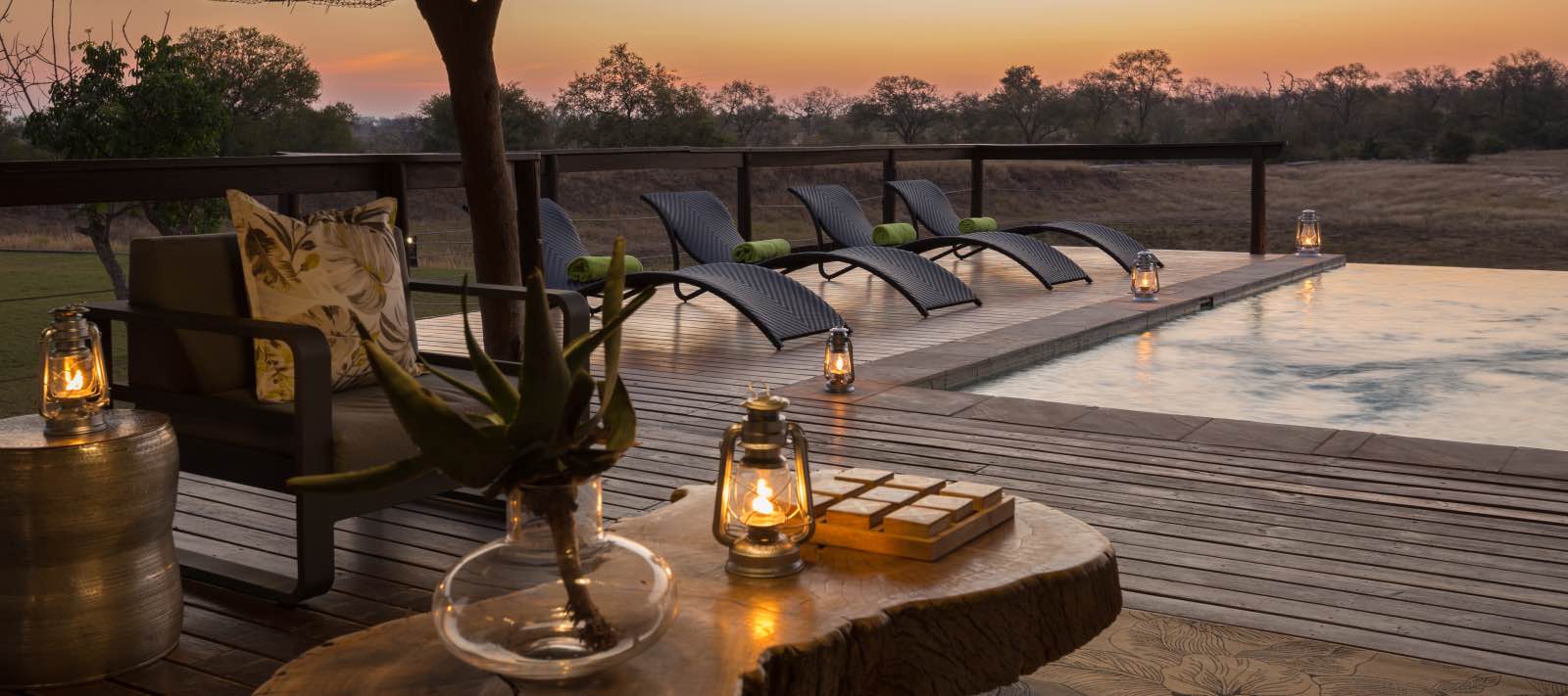 Sunset at the infinity pool, watching the activity on the open plain at Arathusa Safari Lodge