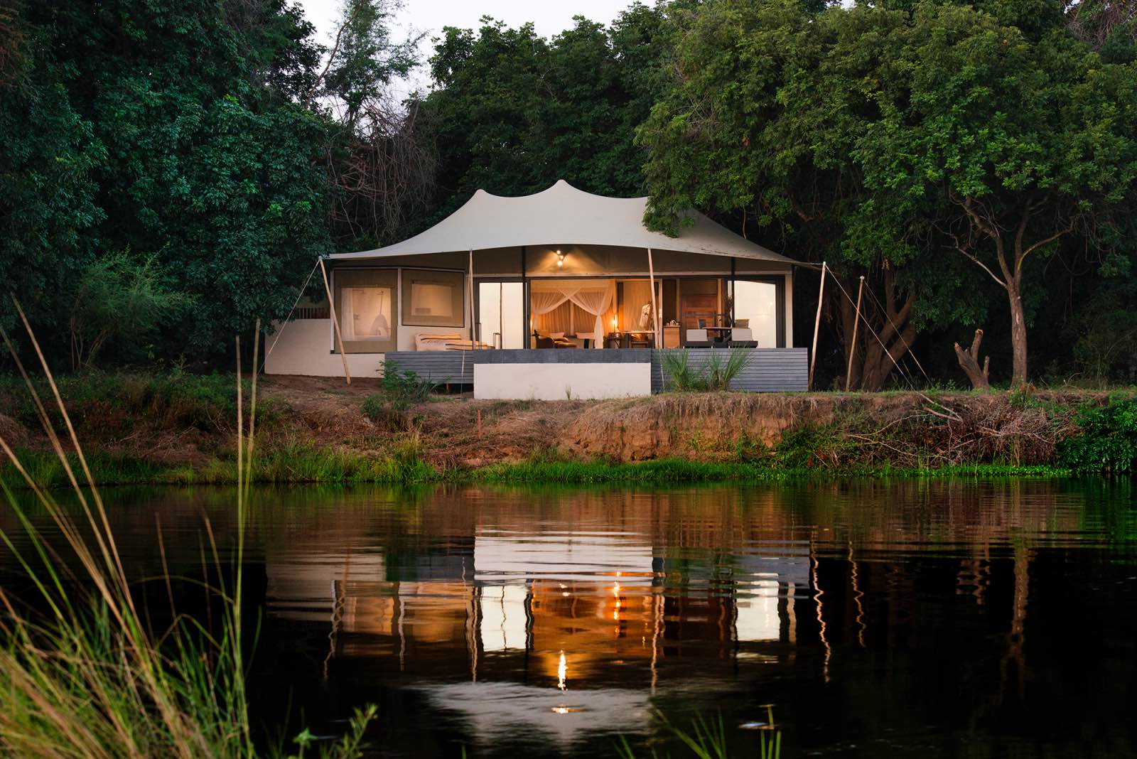 Sausage Tree Camp Luxury Suite on the amid the trees and along the water's edge