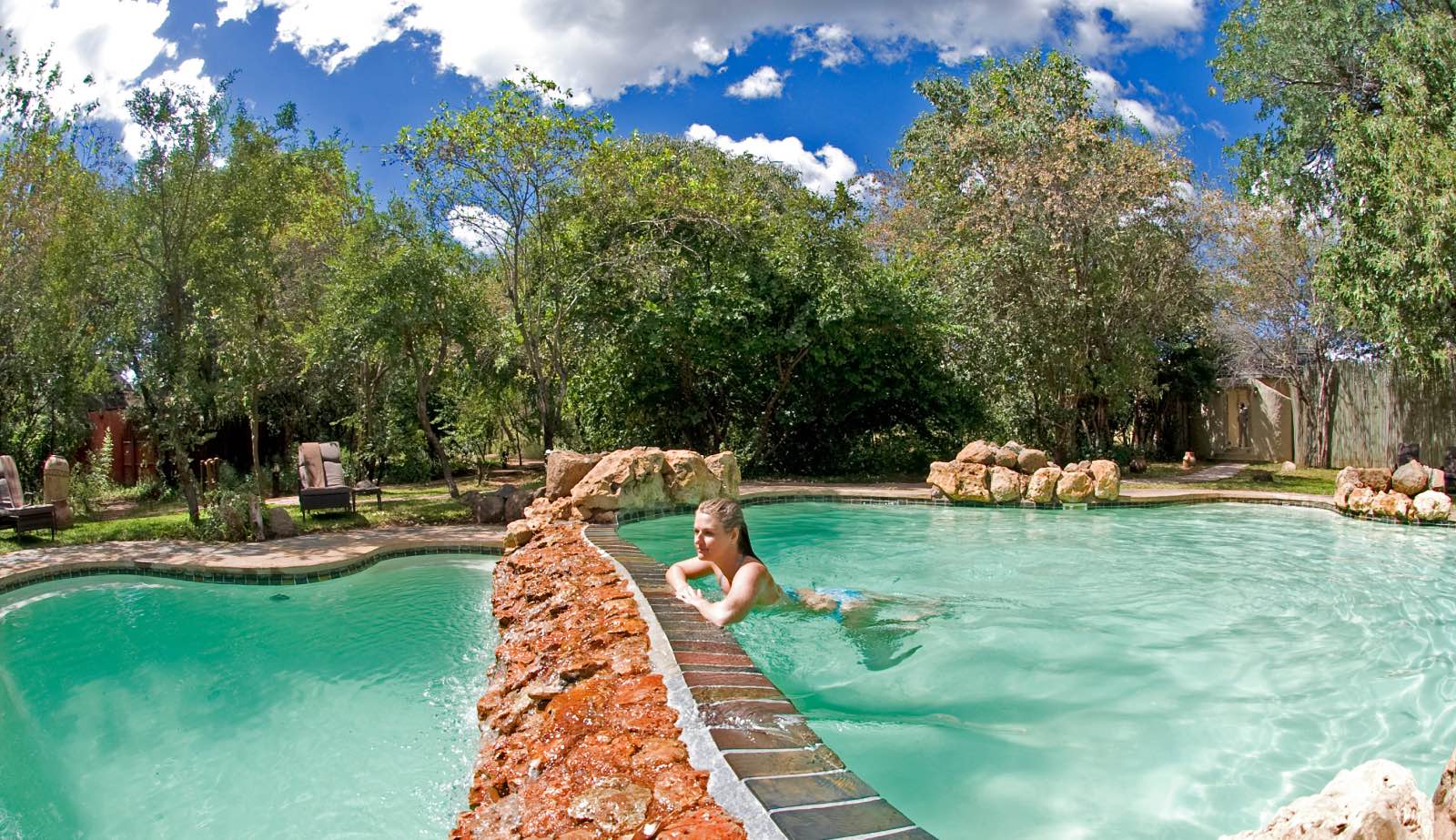 A refreshing swimming pool with a view of the Chobe River below at Chobe Chilwero