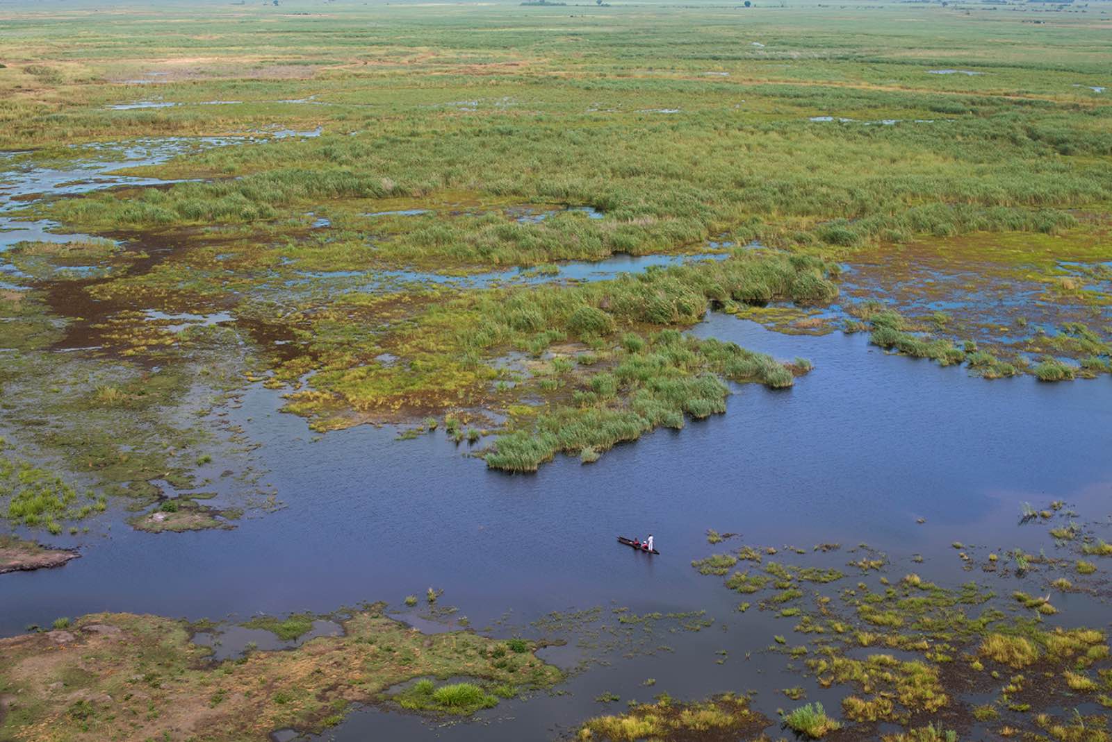 Aerial view of Linyanti swamps with guests on a peaceful mokoro cruise through the lagoon