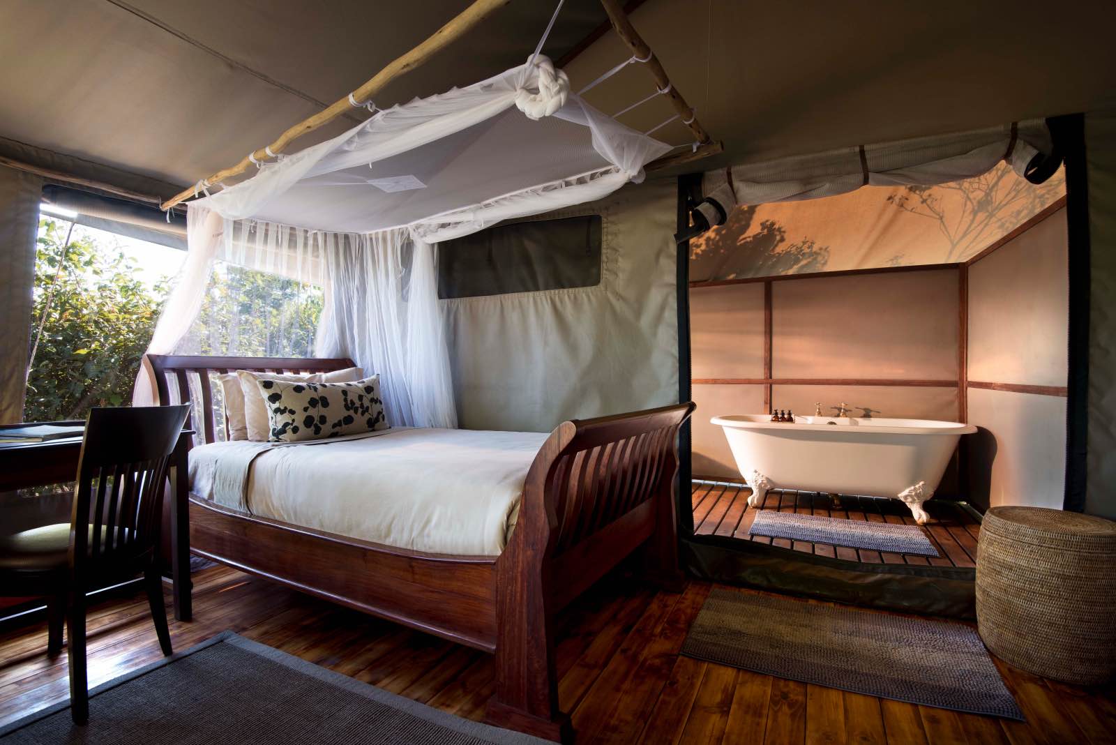 Inside the tented rooms at Linyanti Ebony with wooden floors and bath tubs