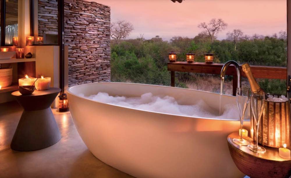 RockFig Safari Lodge ensuite bathroom with candlelit bath tub and a view