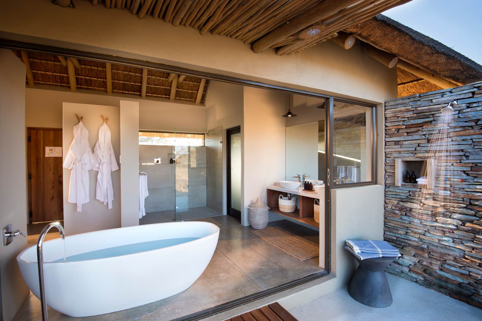 Rockfig en suite bathroom with indoor and outdoor shower and bath tub with a view