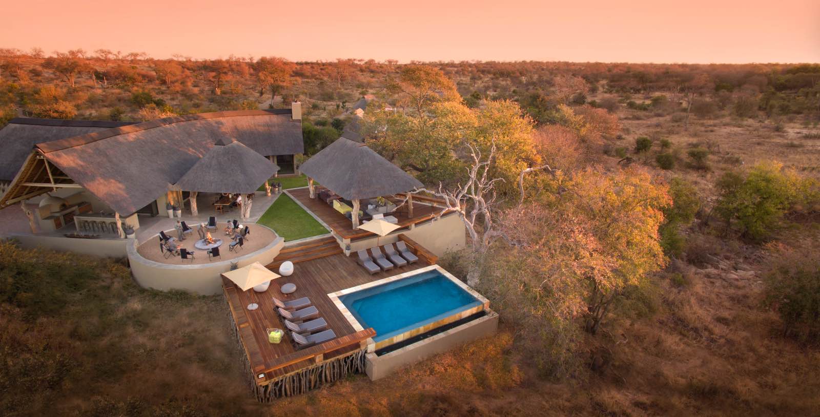 Rockfig from the air looking down on the pool, boma, and main lodge under thatch