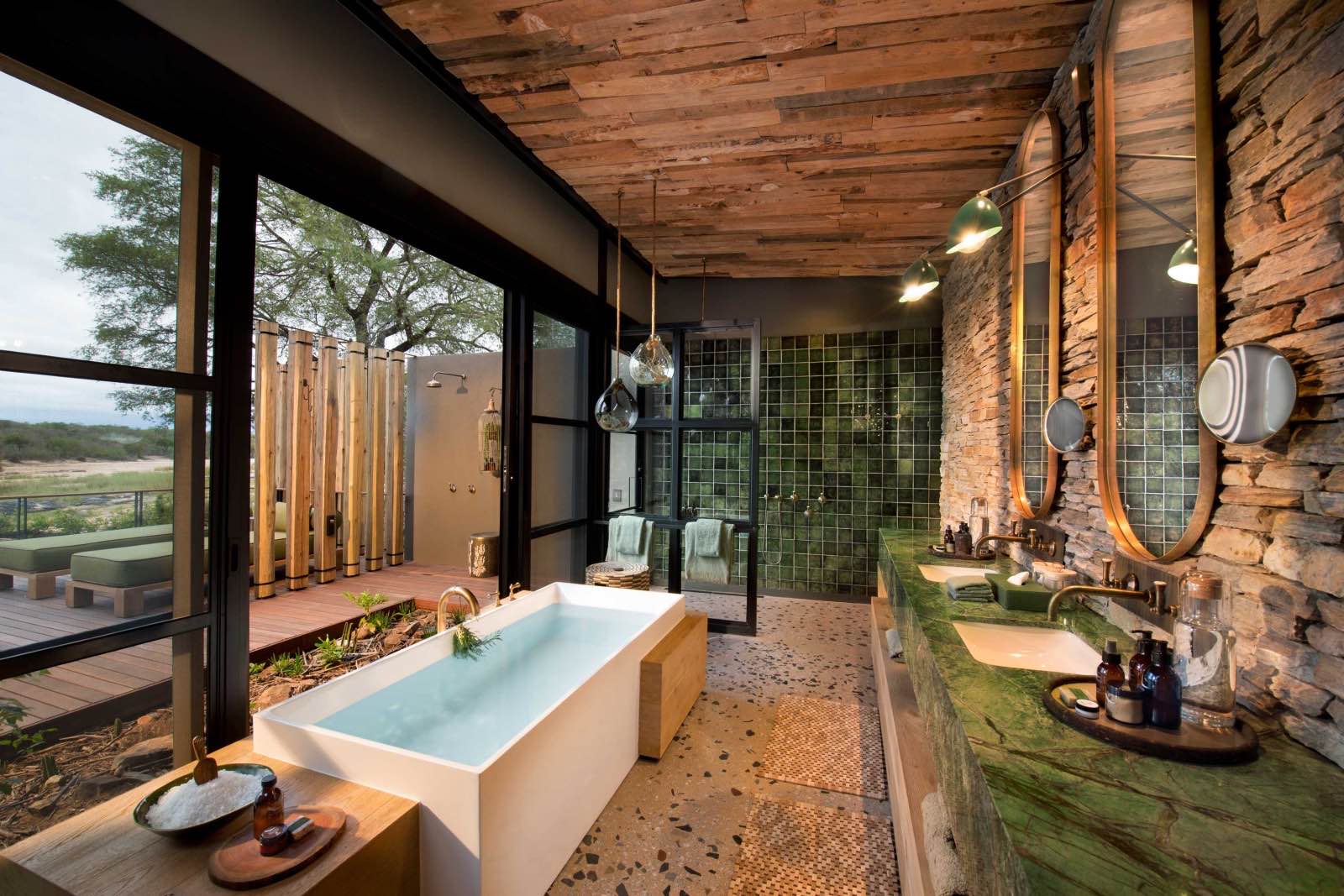 A bath with a view and an outdoor shower in en suite bathrooms