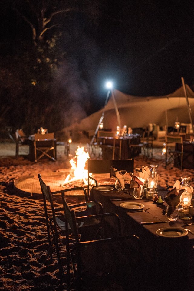 Eating outdoors under the stars alongside a roaring fire in the Kruger National Park