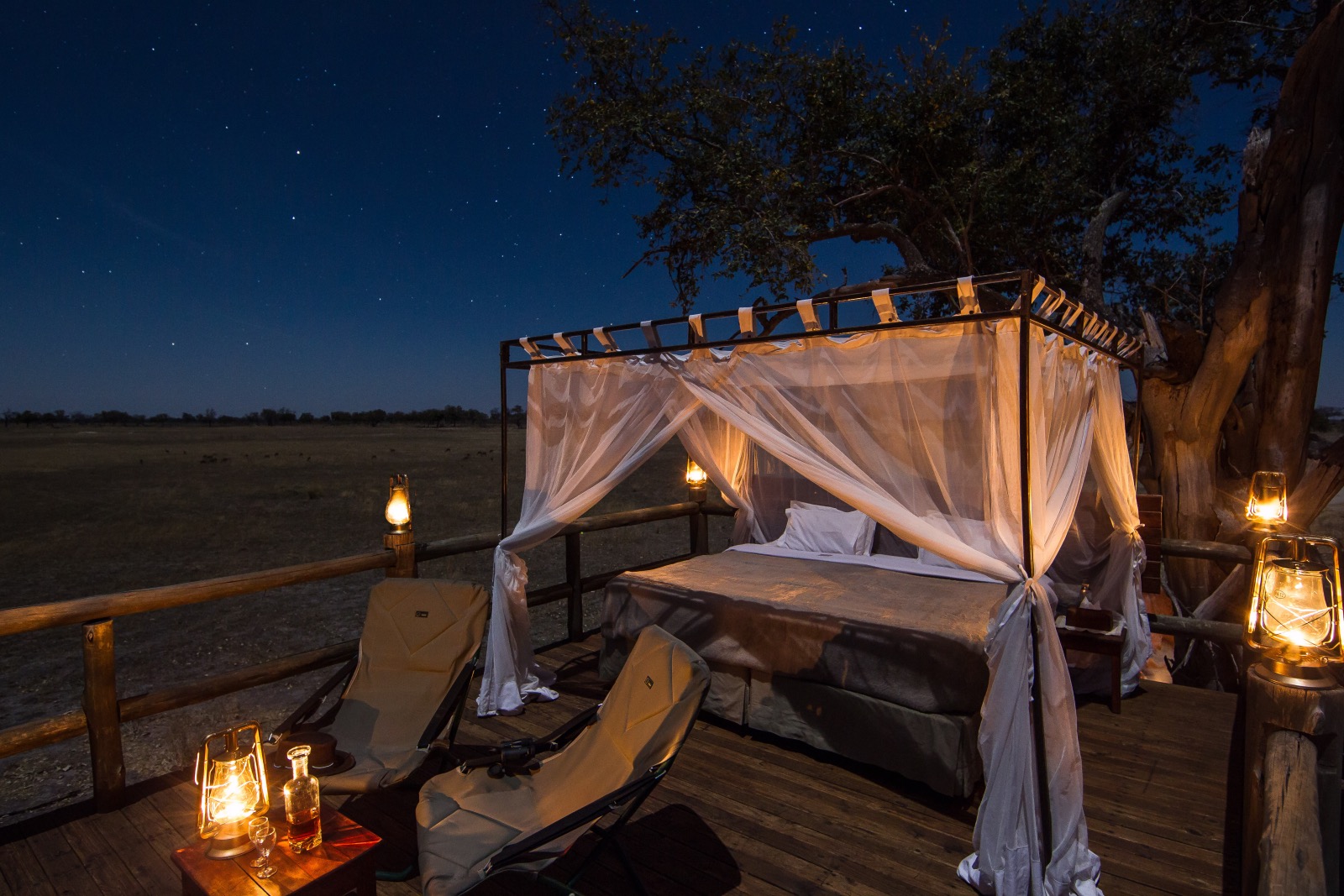 A romantic setting of a bed under the stars in wild Botswana