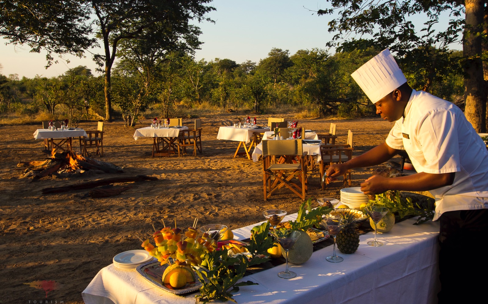 A chef puts finishing touches on the table at a bush dinner in Botswana.