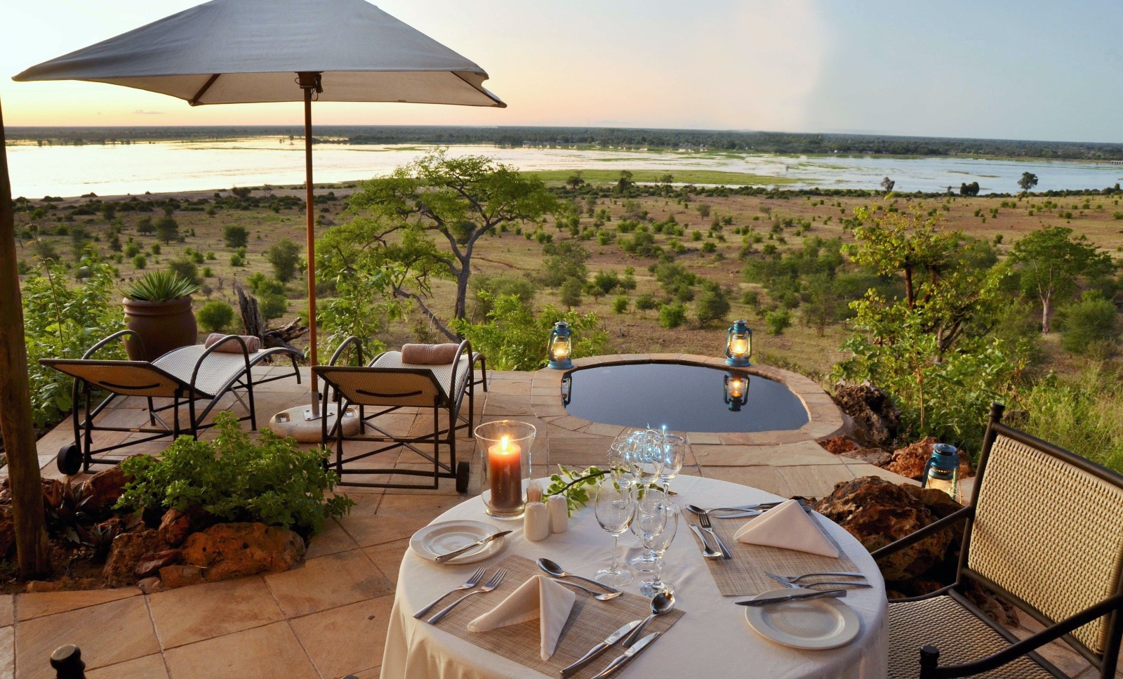 Romantic dinner for two set up on a private deck overlooking the landscape in Botswana.