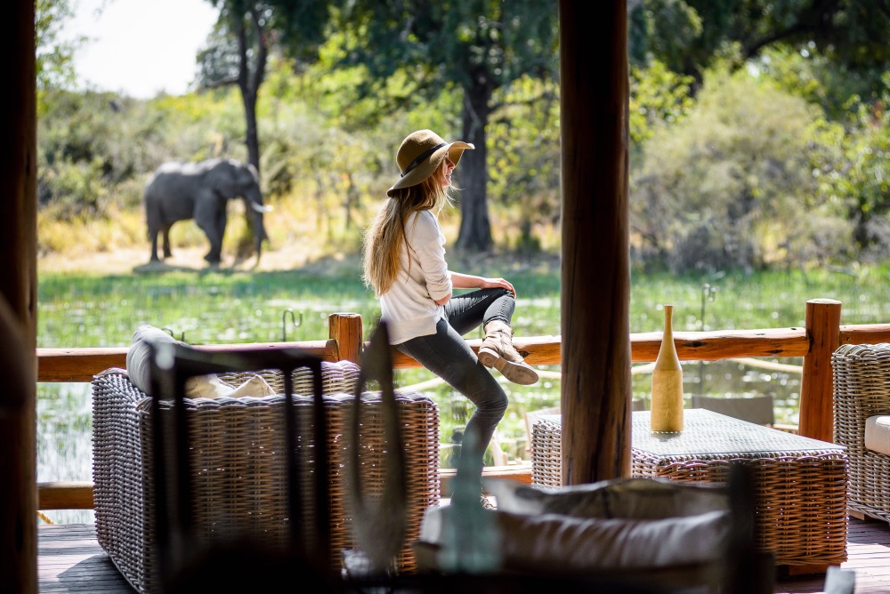 Solo traveller on safari with an elephant in the background