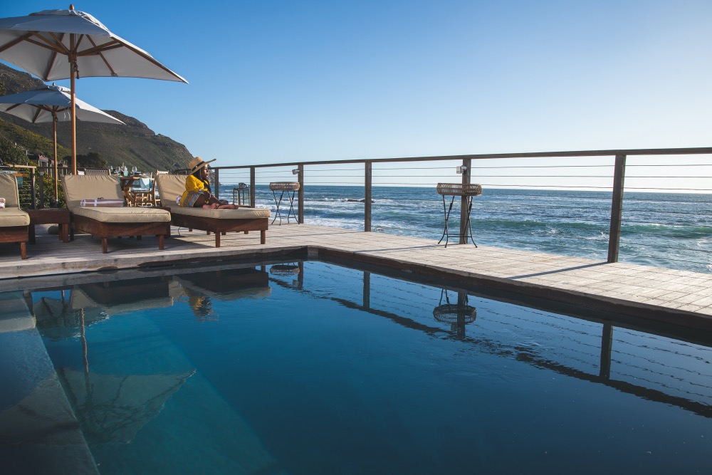 Relaxing poolside and looking onto the ocean at Tintswalo Atlantic