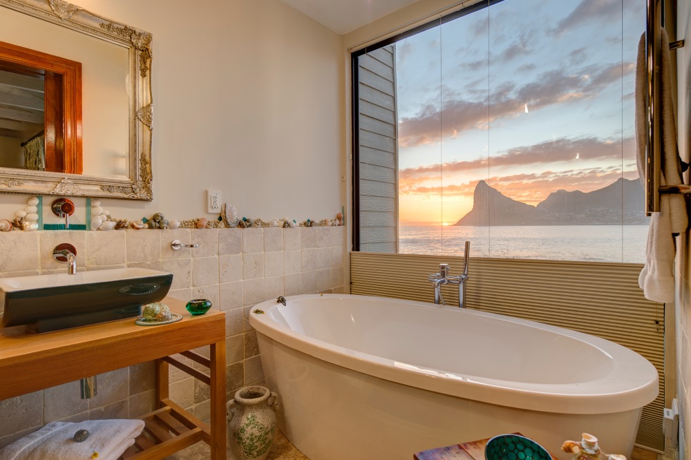 Sunset seen from the bath tub in one of Tintswalo Atlantic's beautiful ocean-view suites
